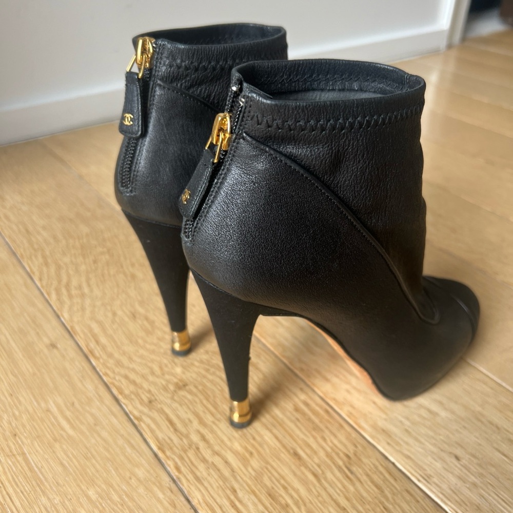 CHANEL Black and Gold Heeled Boots with Stiletto Design